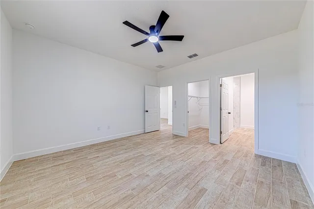 a bathroom with a sink a toilet a mirror a vanity and bathtub