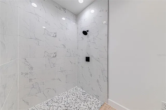 an empty room with wooden floor and ceiling fan