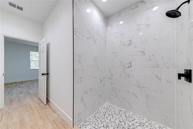 an empty room with a window and a ceiling fan