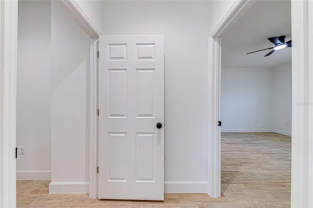 a view of a hallway with wooden floor