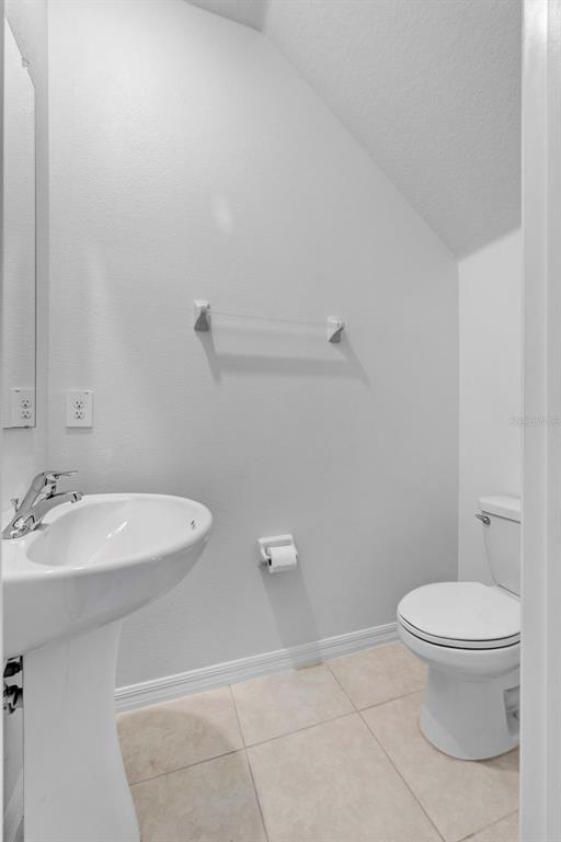 8309 Corner Pine Way New Port Richey, FL 34655 - Photo 11 of 33 a bathroom with a toilet a sink and mirror
