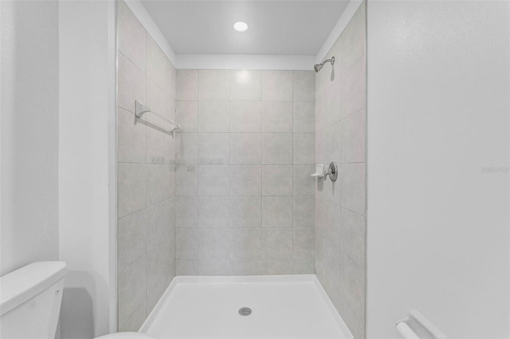 8309 Corner Pine Way New Port Richey, FL 34655 - Photo 18 of 33 a bathroom with a shower and a toilet