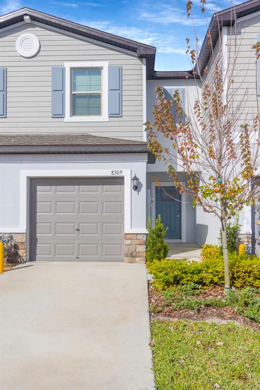 8309 Corner Pine Way New Port Richey, FL 34655 - Photo 2 of 33 front view of a house with a outdoor space