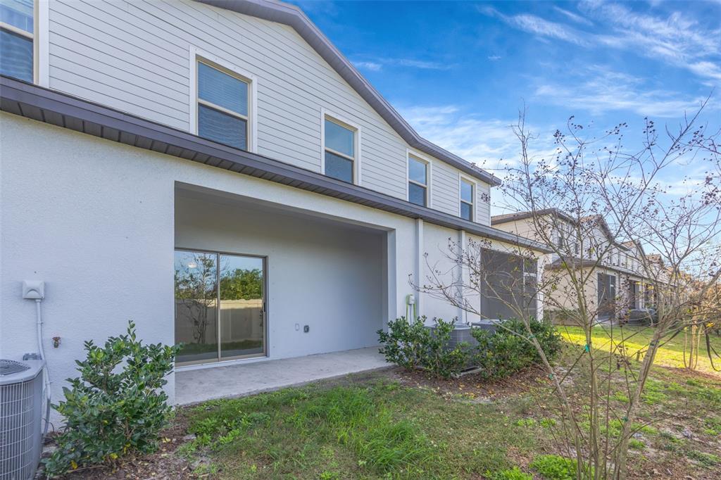 8309 Corner Pine Way New Port Richey, FL 34655 - Photo 28 of 33 a view of a house with a yard