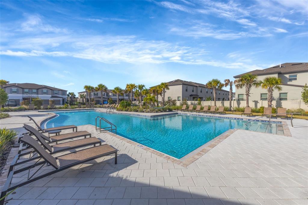 8309 Corner Pine Way New Port Richey, FL 34655 - Photo 30 of 33 a view of a swimming pool and a terrace