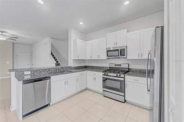 a view of a kitchen with a sink and a refrigerator
