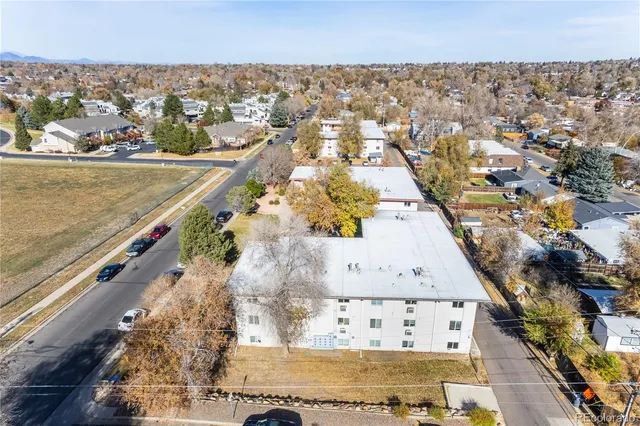 an aerial view of residential houses with outdoor space