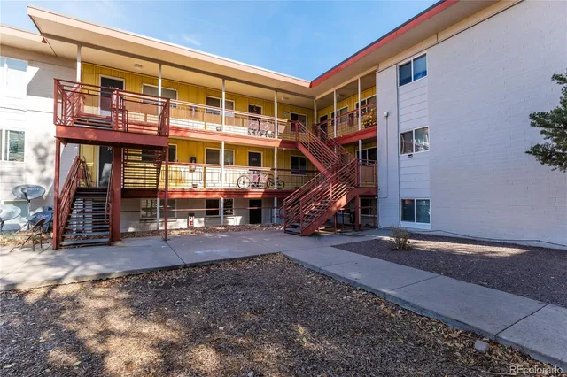 a view of a house with a patio and a yard