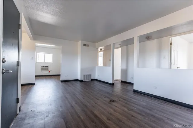 a view of kitchen with wooden floor and electronic appliances