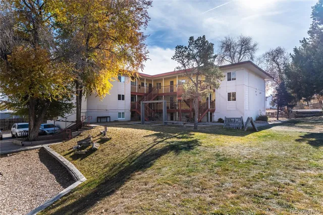 a view of a house with snow on the side of the road