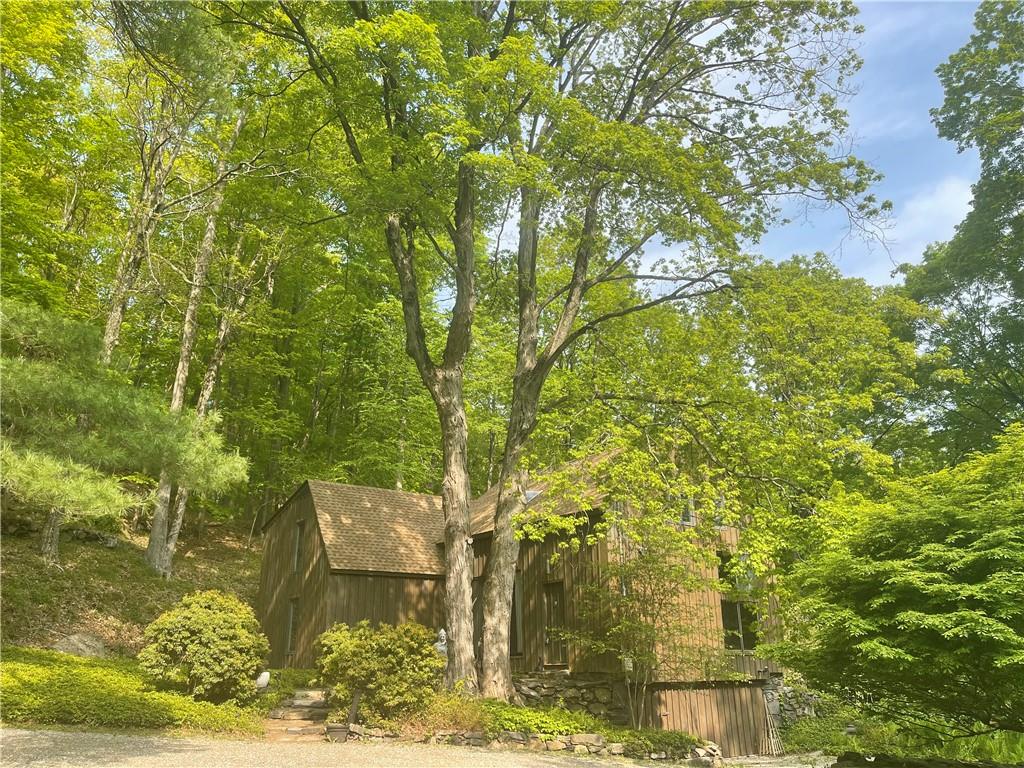 Picturesque country setting on over 4 acres with a pool, flat yard and beautiful mature landscaping.