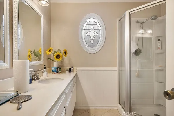 a bathroom with a sink mirror and a shower