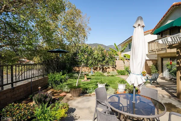a swimming pool with outdoor seating and plants