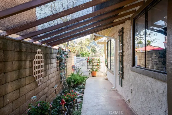 a view of a pathway of a house with a potted plant