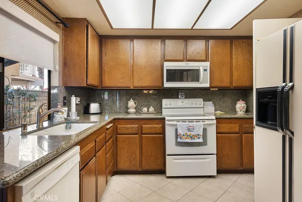 a kitchen with a stove a sink and a refrigerator