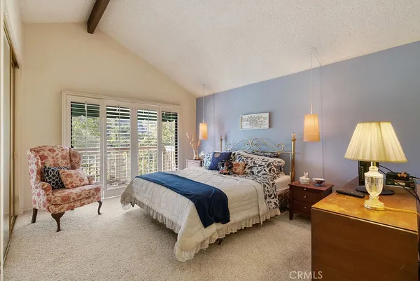 a bed room with a bed and a lamp