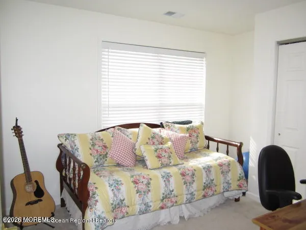 a bedroom with a bed and a large window