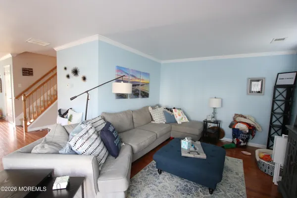 a living room with furniture a rug and a window