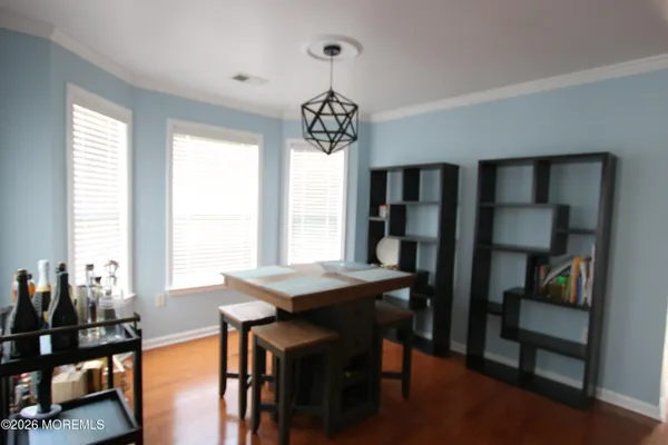 a view of a dining room with furniture and window