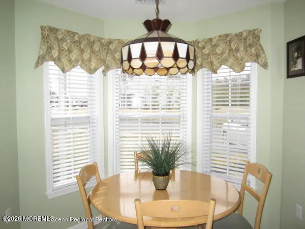 a view of a dining room with furniture window and outside view