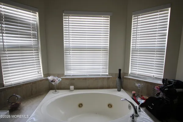 a bathroom with a bathtub and next to a window