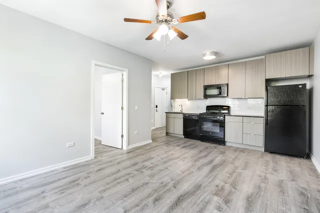 a kitchen with a refrigerator a stove top oven a sink and dishwasher