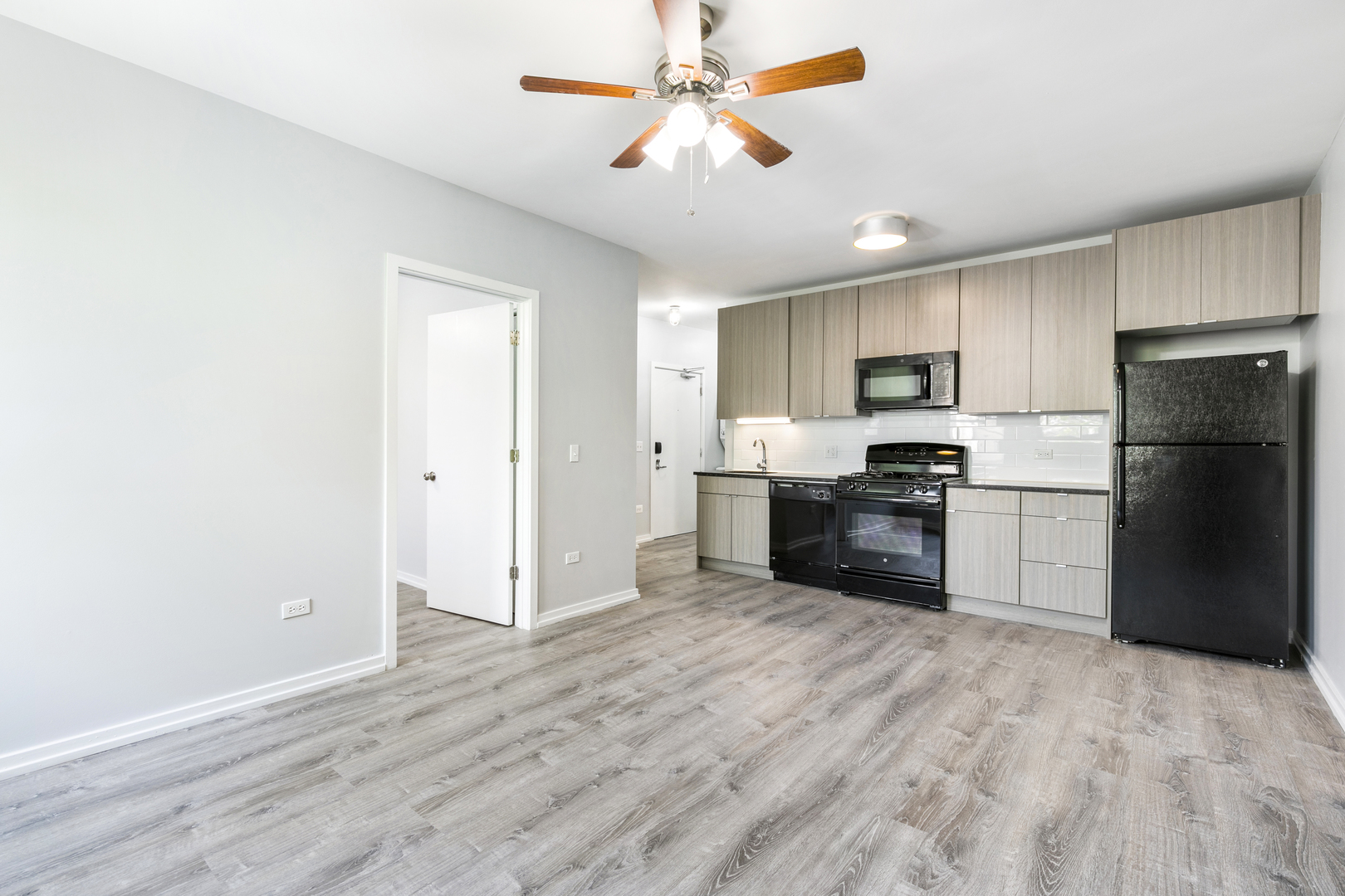 4875 North Magnolia Avenue, Unit 201 Chicago, IL 60640 - Photo 2 of 12 a kitchen with a refrigerator a stove top oven a sink and dishwasher
