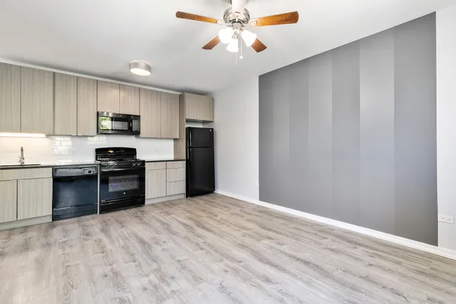 a kitchen with granite countertop a refrigerator stove top oven and sink