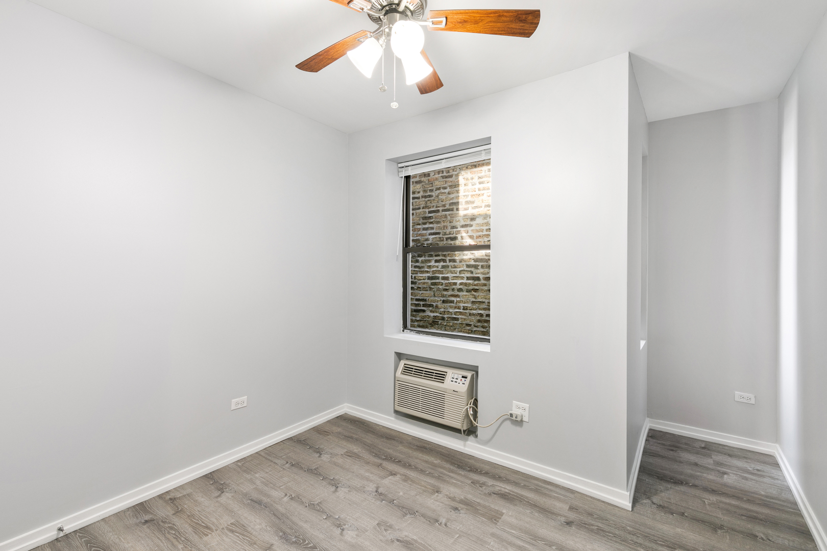 4875 North Magnolia Avenue, Unit 201 Chicago, IL 60640 - Photo 6 of 12 an empty room with windows and fan