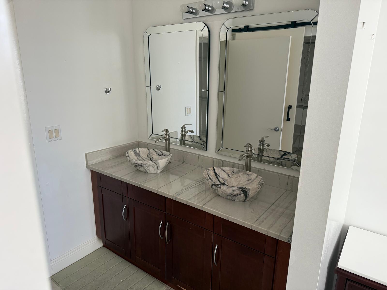7275 Southwest 90th Way, Unit 311 Miami, FL 33156 - Photo 11 of 17 a bathroom with a granite countertop sink and a mirror