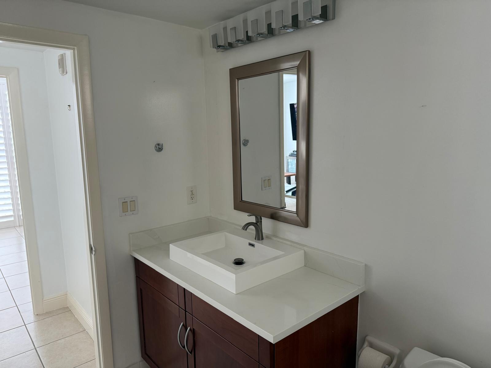 7275 Southwest 90th Way, Unit 311 Miami, FL 33156 - Photo 7 of 17 a bathroom with a sink and a mirror