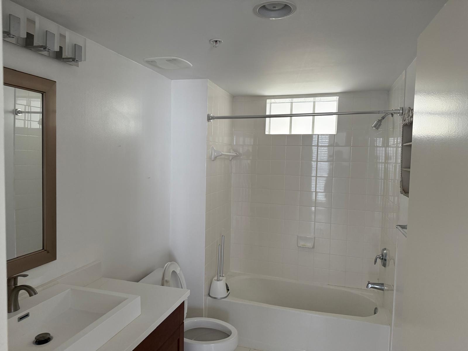 7275 Southwest 90th Way, Unit 311 Miami, FL 33156 - Photo 8 of 17 a bathroom with a sink and a shower