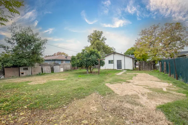 a house with huge green field in front of it