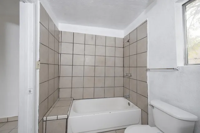 a bathroom with a bathtub and window