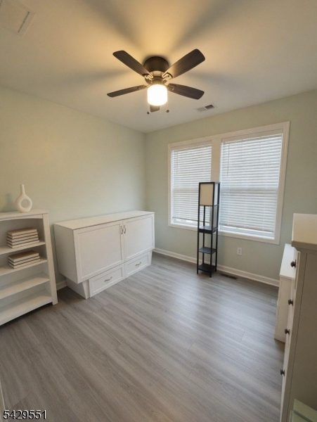 5 West River Styx Road, Unit 301 Hopatcong, NJ 07843 - Photo 6 of 8 a view of room with wooden floor and ceiling fan