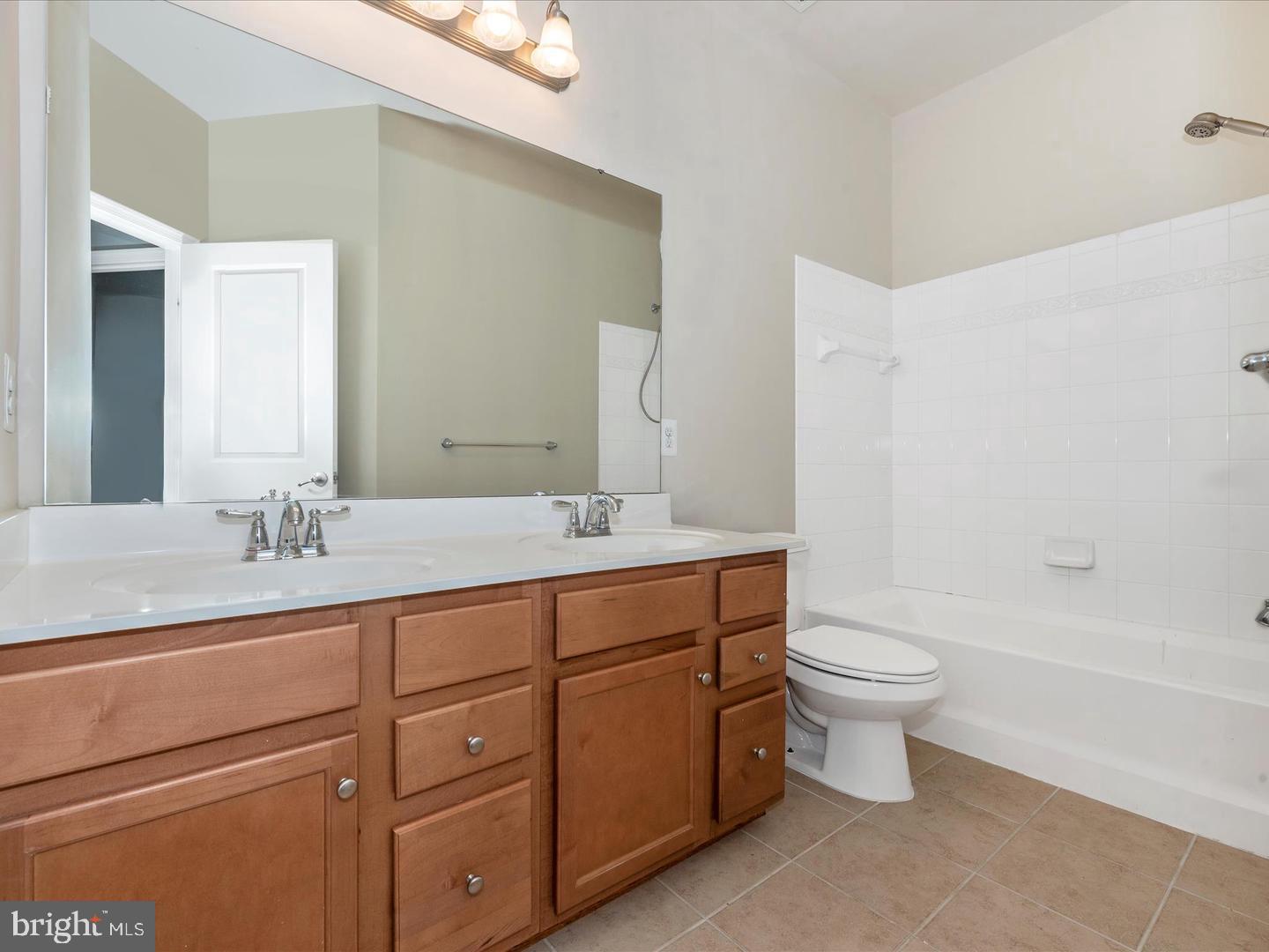208 B Mill Pond Road Frederick, MD 21701 - Photo 33 of 45 a bathroom with a double vanity sink a toilet and a bathtub