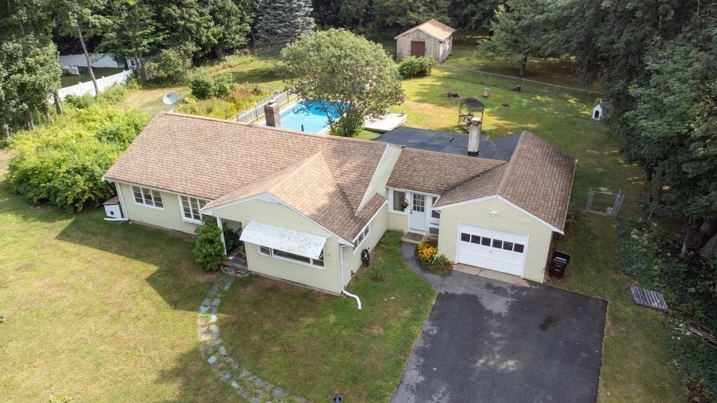 an aerial view of a house with swimming pool and outdoor space