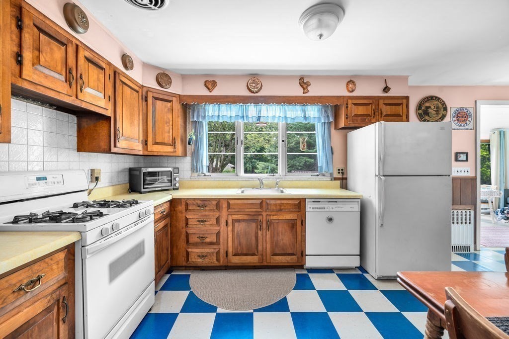 12 Kimball Road Amesbury, MA 01913 - Photo 3 of 36 a kitchen with a stove a sink and a refrigerator