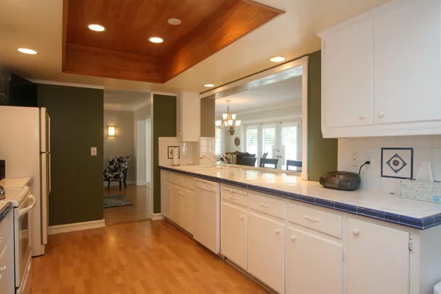 a kitchen with granite countertop a refrigerator and sink