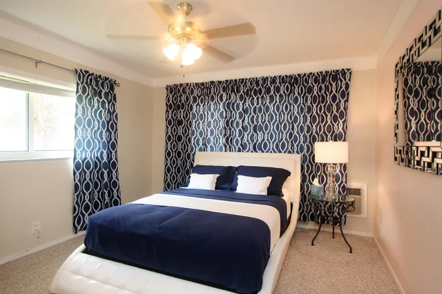 a bedroom with a bed and a chandelier