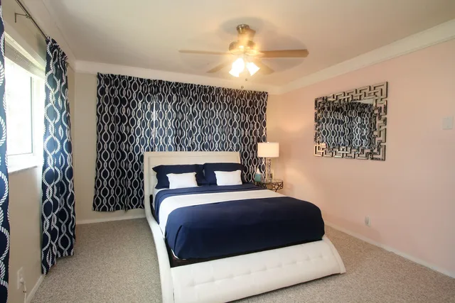 a bedroom with a bed and a lamp