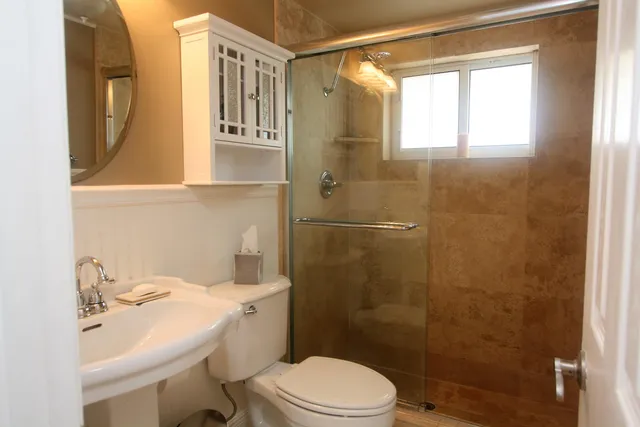 a bathroom with a sink toilet and shower