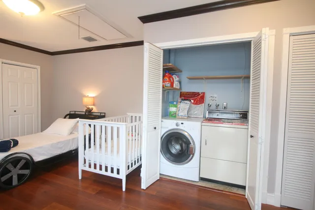 a view of a bedroom with washer and dryer