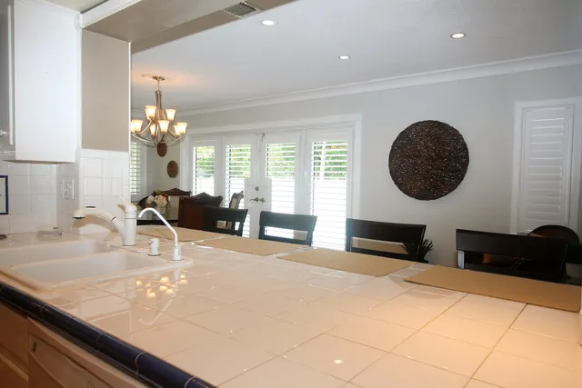 a bedroom with a large bed and a large mirror