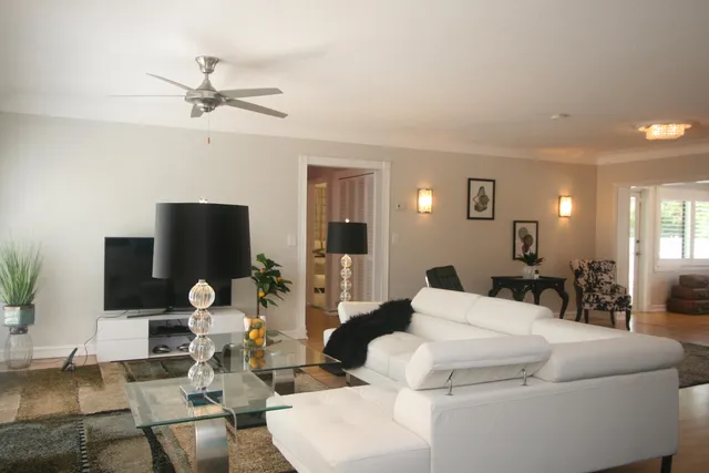 a living room with furniture a rug and a flat screen tv