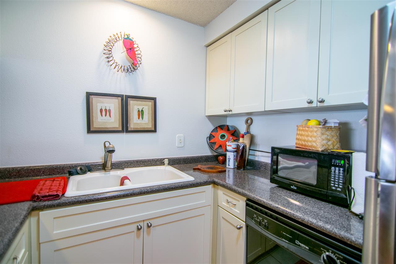 1450 South Kihei Road, Unit A205 Kihei, HI 96753 - Photo 14 of 24 a kitchen with a sink cabinets and stainless steel appliances