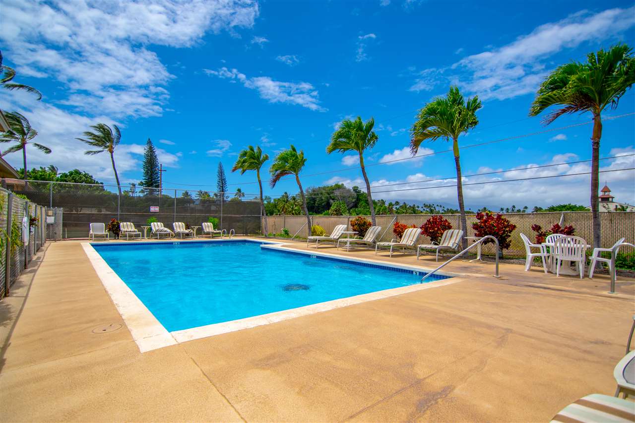 1450 South Kihei Road, Unit A205 Kihei, HI 96753 - Photo 21 of 24 a view of a swimming pool with a table and chairs