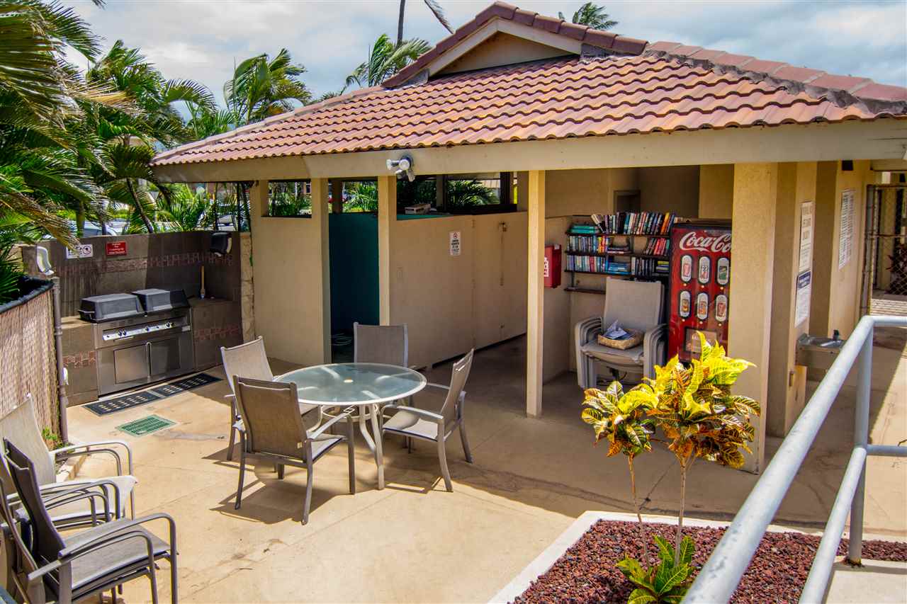 1450 South Kihei Road, Unit A205 Kihei, HI 96753 - Photo 23 of 24 a view of a patio with table and chairs potted plants
