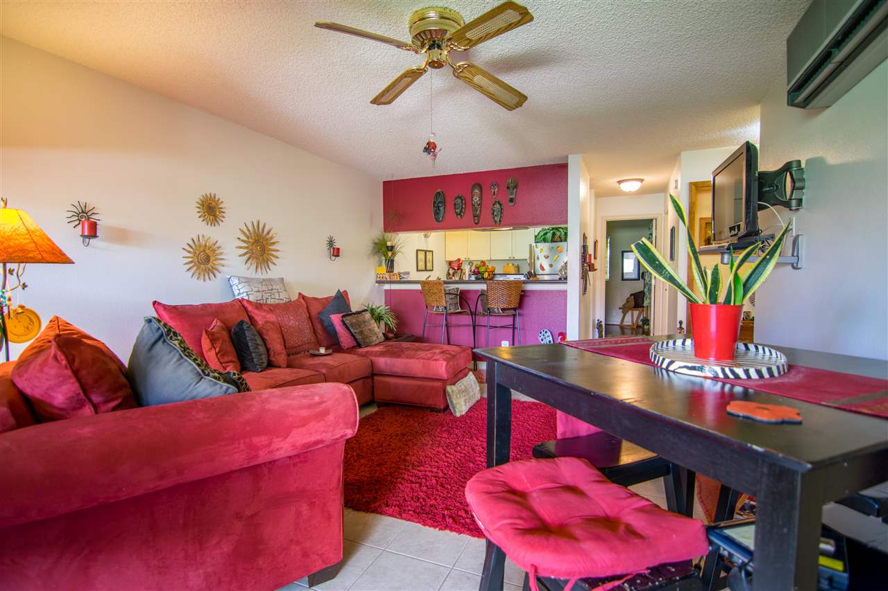 1450 South Kihei Road, Unit A205 Kihei, HI 96753 - Photo 6 of 24 a living room with furniture a rug and a flat screen tv