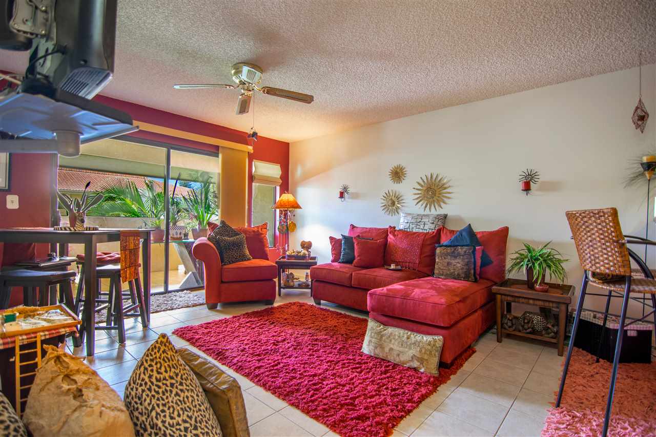 1450 South Kihei Road, Unit A205 Kihei, HI 96753 - Photo 8 of 24 a living room with furniture a rug and a large window